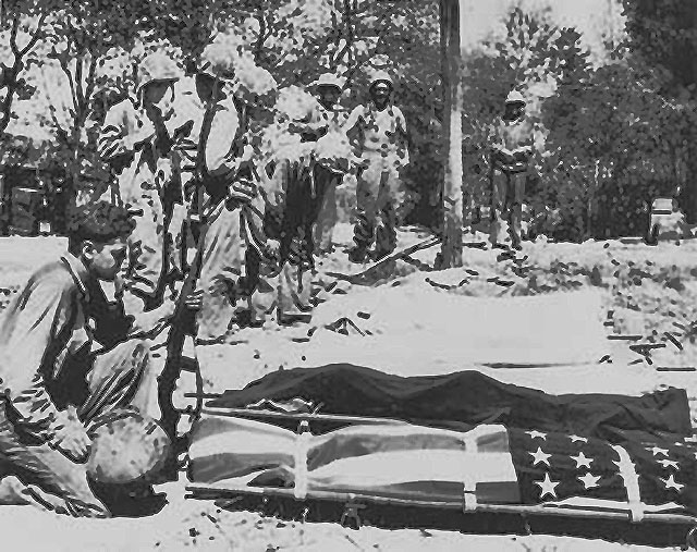 The cost of battle. Fellow Marines mourn as a buddy is to be buried.
