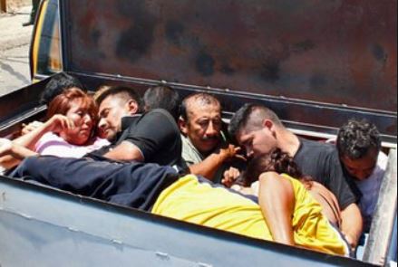 Illegal immigrants piled up in the back of a truck.