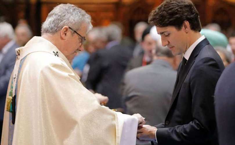 Justin Trudeau being publicly rewarded by Monsignor Christian L�pine, 2017-May-18 in Montreal.